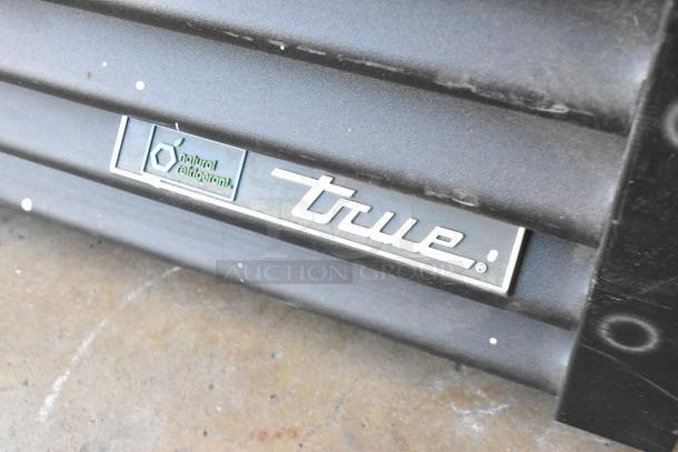 True GDM-26-HC commercial cooler tag, showing "True" logo and "natural refrigerant" label, indicating eco-friendly features.