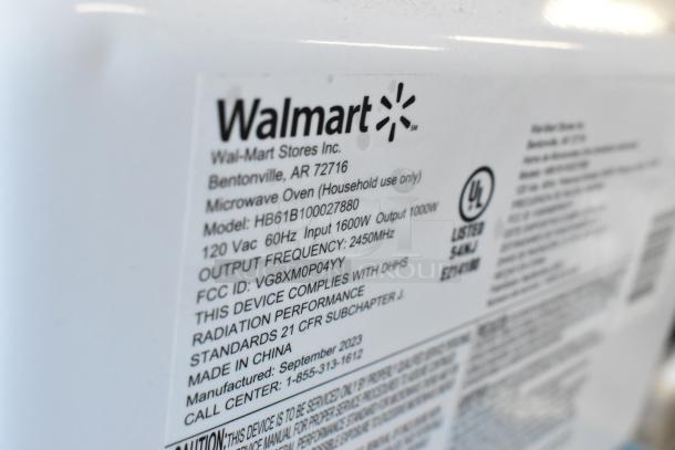 2023 Hamilton Beach HB61B100027880 countertop microwave, 115V, 1 Phase, with label showing model, voltage, and safety certifications.