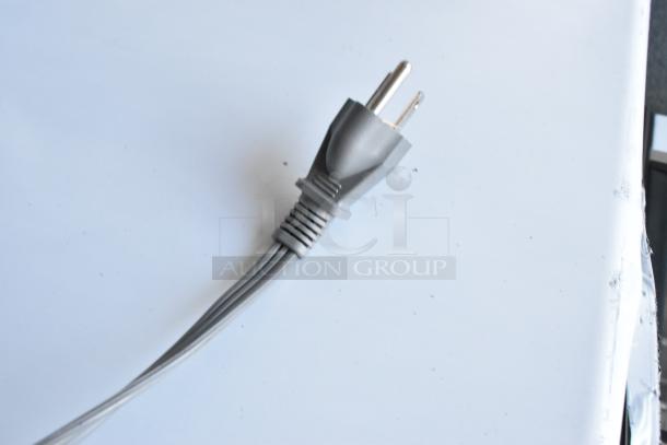 Close-up of a power cord plug from the Hamilton Beach HB61B100027880 microwave, showing a two-prong design.
