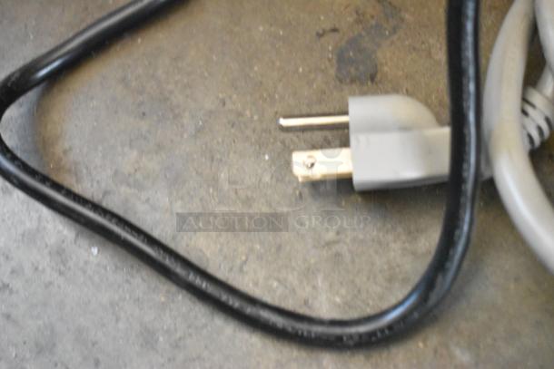Stainless steel plug and cord of an Amana RCS10TS countertop microwave oven. 120 volts, 1 phase.