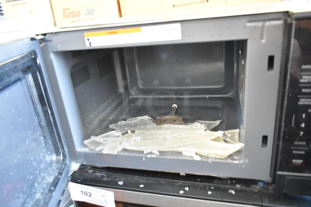 Hamilton Beach MS8436193153-03 metal countertop microwave, 115V, open door with debris inside, fair condition.