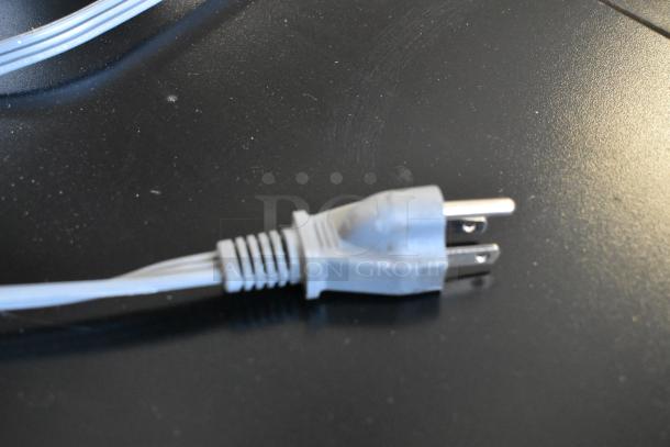Close-up of a gray electrical plug for the Hamilton Beach MS8436193153-03 microwave, suitable for 115 volts, 1 phase.