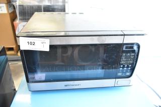 Emerson MW9339SB metal countertop microwave with control panel and glass door. Auction tag "102 QTY 1" attached.