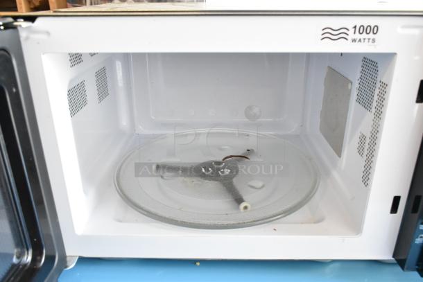 Hamilton Beach HB61S100027880 metal countertop microwave oven, 1000 watts, interior with glass plate shown.