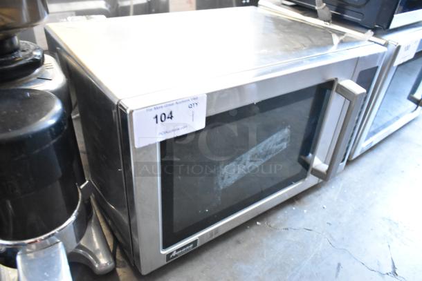2021 Amana RCS10TS metal countertop microwave oven with plate, 115 volts, 1 phase, visible wear. Model info label on the front.