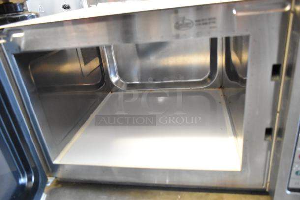 2021 Amana RCS10TS metal countertop microwave, 115 volts, 1 phase. Clean interior, includes plate.