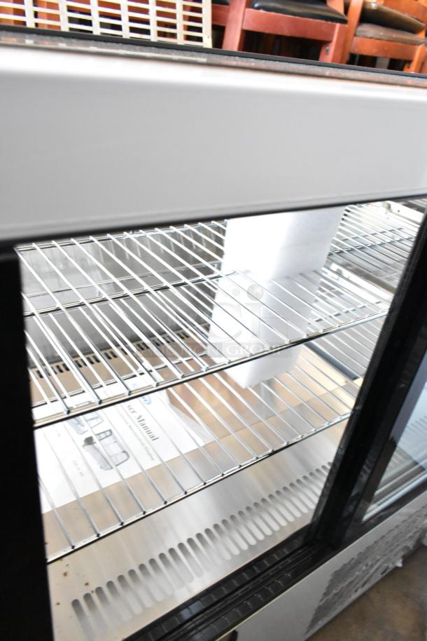 Brand new KoolMore CDC-4C-BK 27" commercial countertop refrigerator display case, featuring shelves and glass door. Scratch and dent condition.