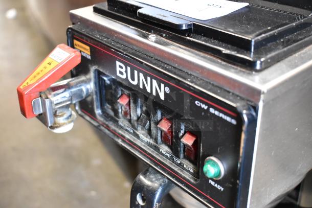 Bunn CWTF15 stainless steel coffee machine, 3 burners, hot water dispenser, metal brew basket. Visible controls and branding.
