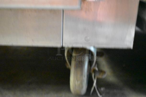 Traulsen RDH232WUT-HHG stainless steel 2-section cabinet; shown focus on commercial caster wheel.