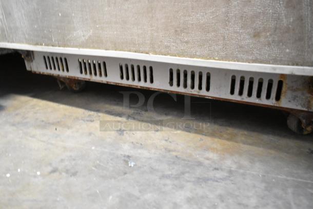 Berg BVER23 metal commercial single door reach-in cooler, visible casters, some rust, 115 volts, 1 phase, used condition.