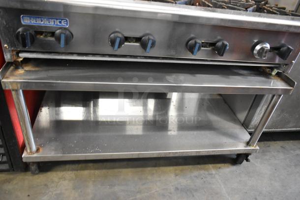 Radiance 6-burner stainless steel gas range with backsplash, shelves, and casters; signs of use visible.