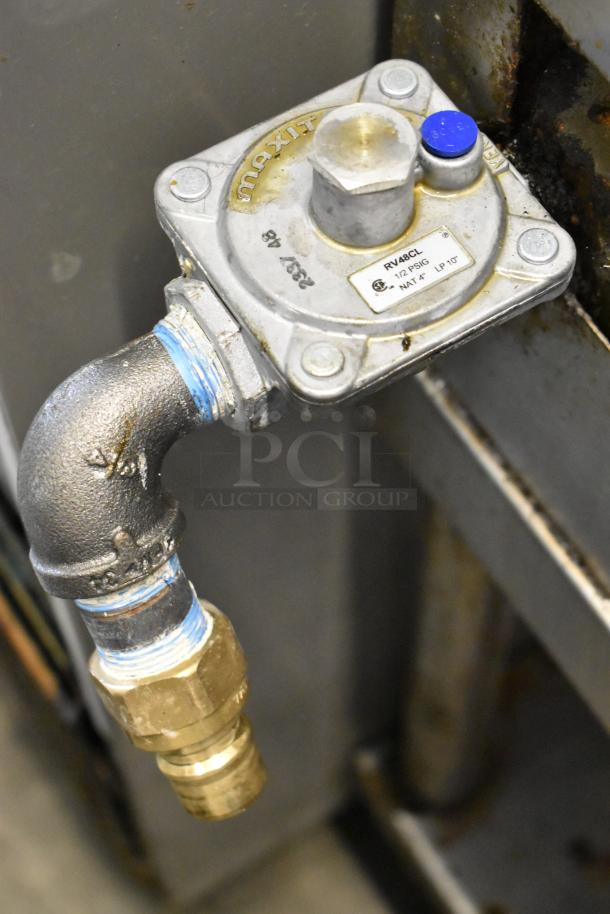 Gas connection of Radiance stainless steel commercial 6-burner range, featuring MAXIT regulator, RV48CL, and brass fittings.