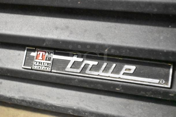 True GDM-37-LD metal 2-door cooler merchandiser, poly-coated racks, 115 volts, 1 phase. Features True Manufacturing logo.