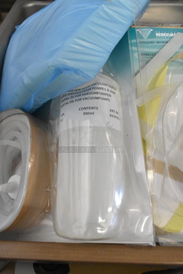 Henkelman Jumbo 42 XL service kit, including 300ml vacuum pump oil and accessories, in new condition.