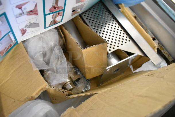 Henkelman Jumbo 42 XL vacuum sealer parts in a box, showing stainless steel components and packaging.