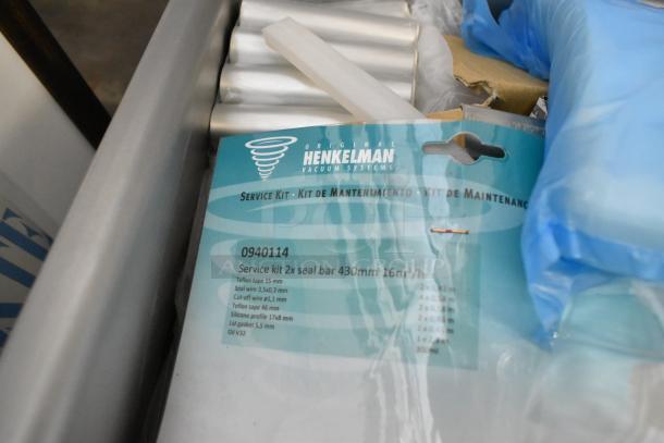 Henkelman Jumbo 42 XL vacuum sealer, stainless steel, 110-120V, with visible service kit label detailing seal bar specifics.