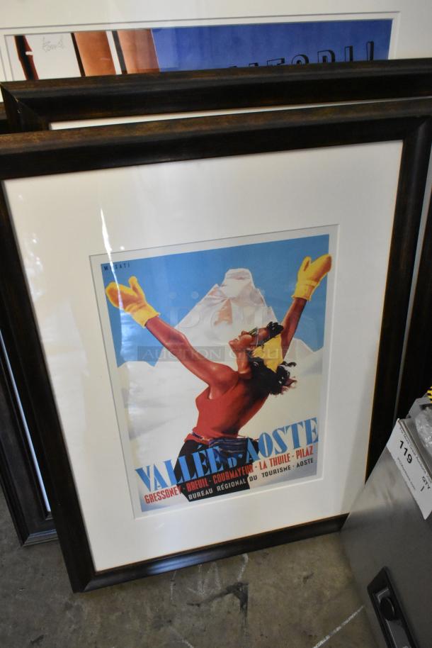 Framed vintage poster featuring person with yellow mittens, set against mountain backdrop. Part of a 12-picture lot.