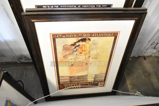 Framed vintage maritime poster with a ship illustration, featuring "Cie de Navigation Sud-Atlantique." Brown wooden frame.