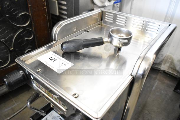 La Cimbali M21 Junior NF stainless steel espresso machine with portafilter and steam wand. 120V, 1 phase. Auction tag visible.