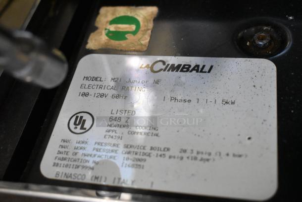La Cimbali M21 Junior NF stainless steel commercial espresso machine label, showing model and electrical info.