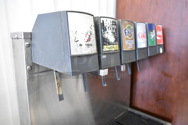 Stainless steel 6-flavor beverage machine with visible wear, featuring Coke, Sprite, and Fanta labels. 115V, 1 phase.