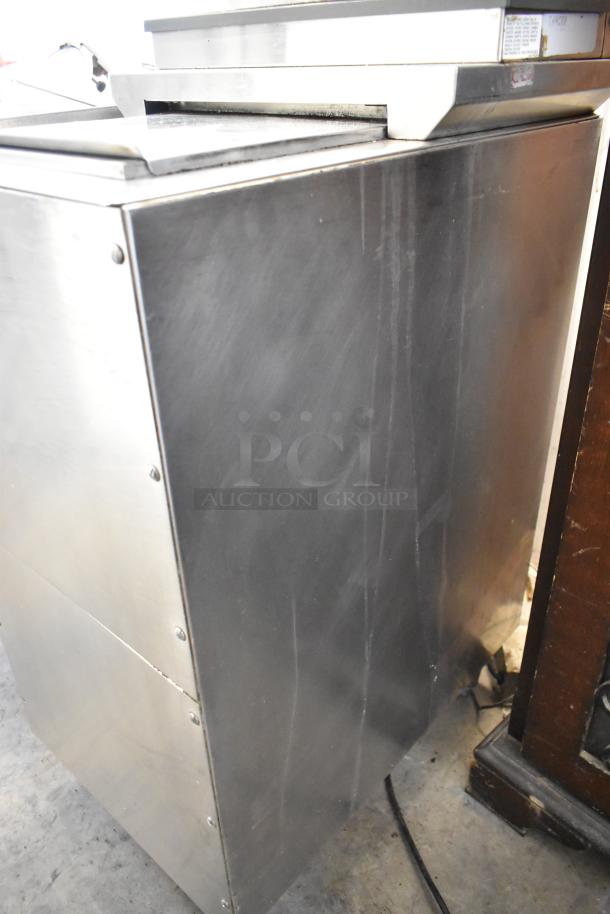 Stainless steel commercial beverage machine with 6 flavor dispensers on an ice bin, 115 volts, 1 phase, good condition.