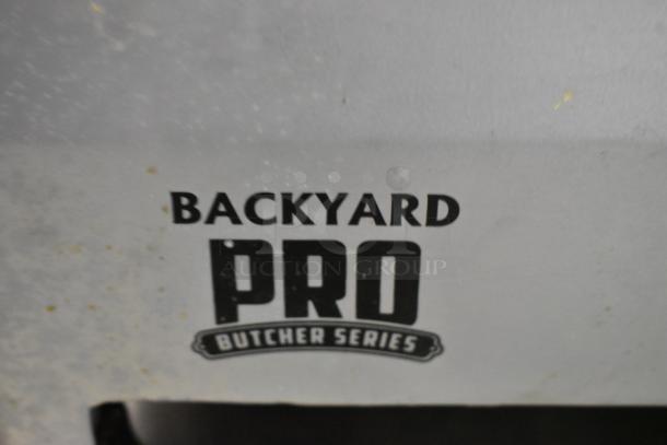 Backyard Pro 554SL112E metal commercial meat slicer with blade sharpener, 115V, 1 phase, Butcher Series branding visible.