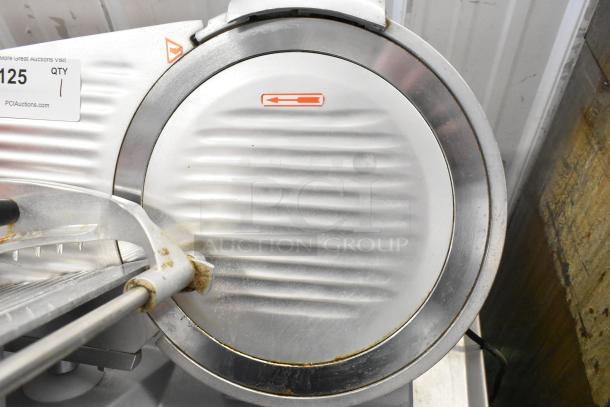 Backyard Pro 554SL112E commercial meat slicer with built-in blade sharpener, stainless steel finish, shows signs of use.