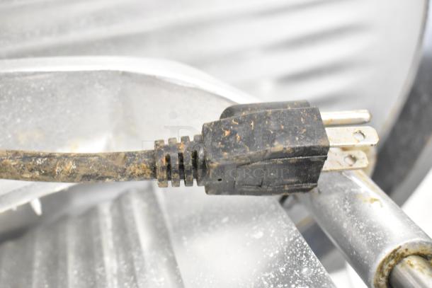 Backyard Pro 554SL112E commercial countertop meat slicer, showing a worn power plug, indicating need for maintenance.