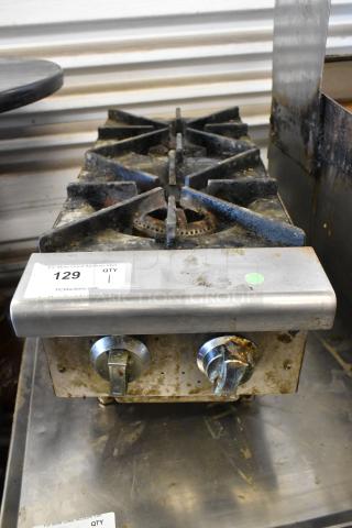Stainless steel commercial countertop gas range with two burners, visible wear, and marked with lot number 129.