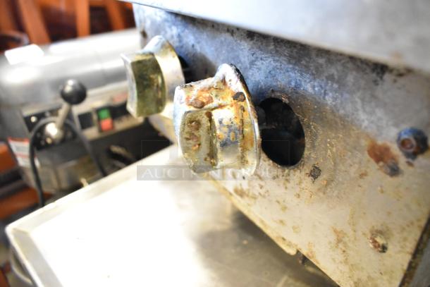Stainless steel commercial countertop 2 burner range with gas power. Visible rust and wear on control knobs. Suitable for heavy-duty use.