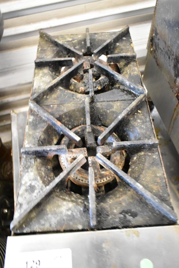 Stainless steel commercial countertop gas-powered 2 burner range, used condition, visible wear and discoloration.