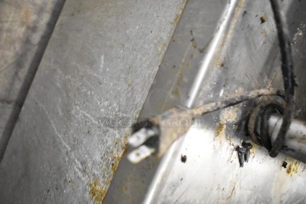 Weathered True TRCB-110 chef base component showing wear and exposed wiring; parts in need of maintenance.
