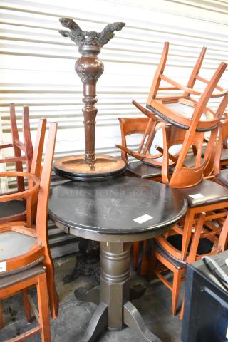 Three wooden round tables, various designs, sturdy pedestal bases, moderate wear, assorted chairs stacked nearby.