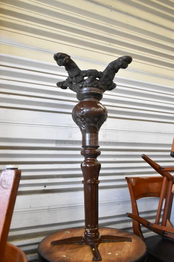 Set of three wooden tables with round tabletops, ornate dark wood pedestal base, visible wear, ideal for vintage décor.