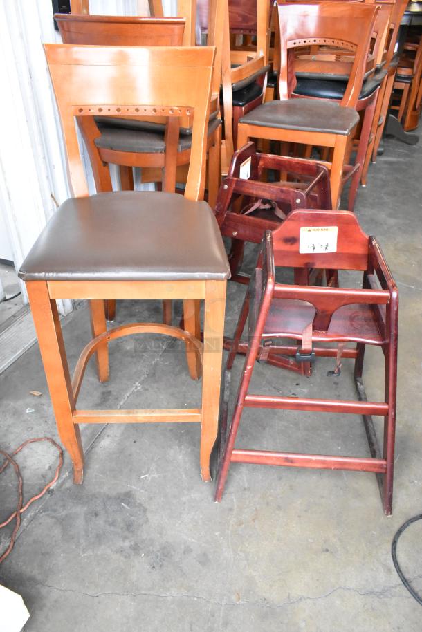 20 wooden chairs, 18 bar-height with brown cushions and 2 high chairs. Auction for 20 times your bid.