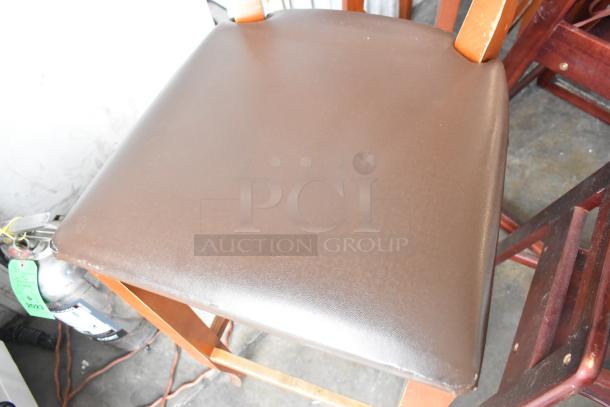 Bar height wooden chair with brown seat cushion, part of 20-item auction lot. Good condition, visible details emphasize quality.