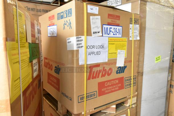 Brand new Turbo Air MUF-28-N stainless steel freezer in box. Features: 115 Volts, 1 Phase. Labels indicate model and handling instructions.