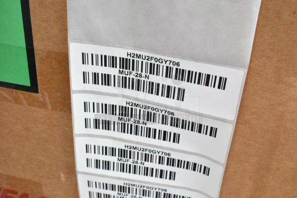 Turbo Air MUF-28-N stainless steel freezer, brand new in box, single door, 115V, with model labels and barcodes visible.