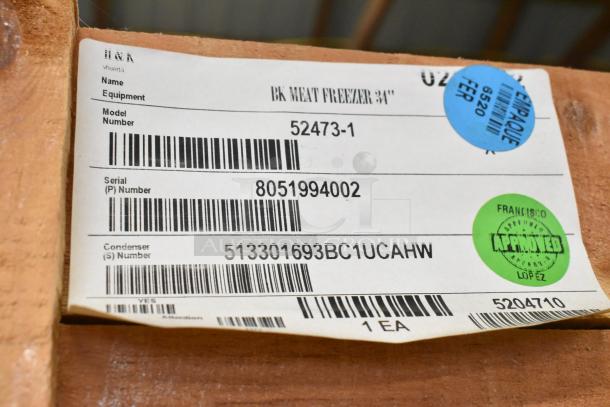 Brand new BKI 52473-1 stainless steel meat freezer in crate, on commercial casters. Label shows model and serial numbers.