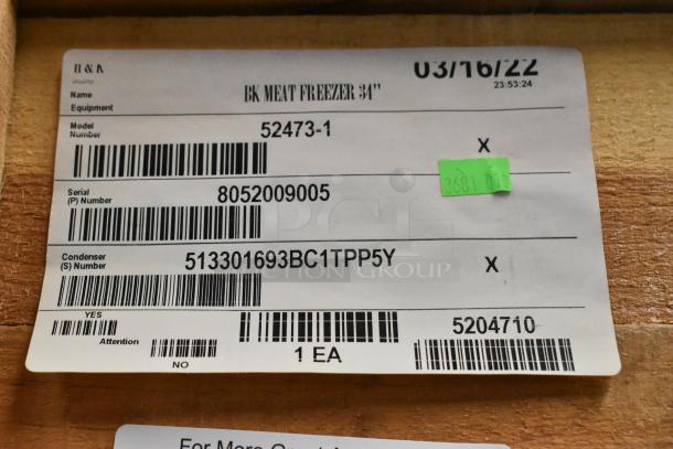 Label of BKI 52473-1 stainless steel commercial meat freezer, new in crate, showing model and serial numbers.