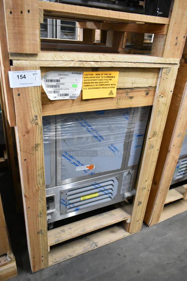 Brand new BKI 52473-1 stainless steel commercial meat freezer in crate, on casters, 115 volts, 1 phase, caution label visible.