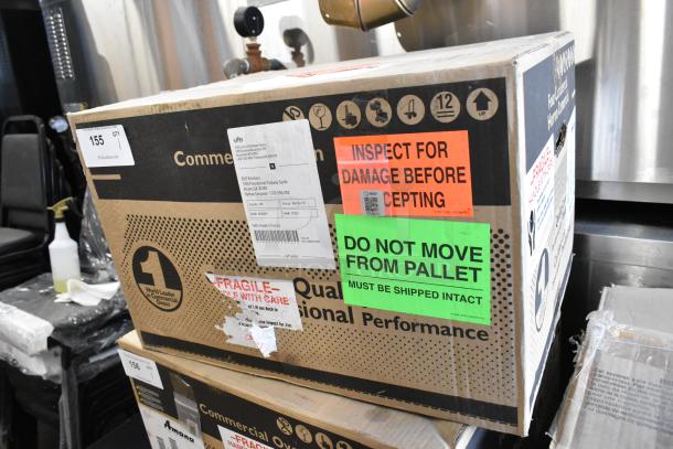 BRAND NEW 2021 Amana RMS10DSA microwave in original crate. Stainless steel, commercial model. Labels indicate handle with care.