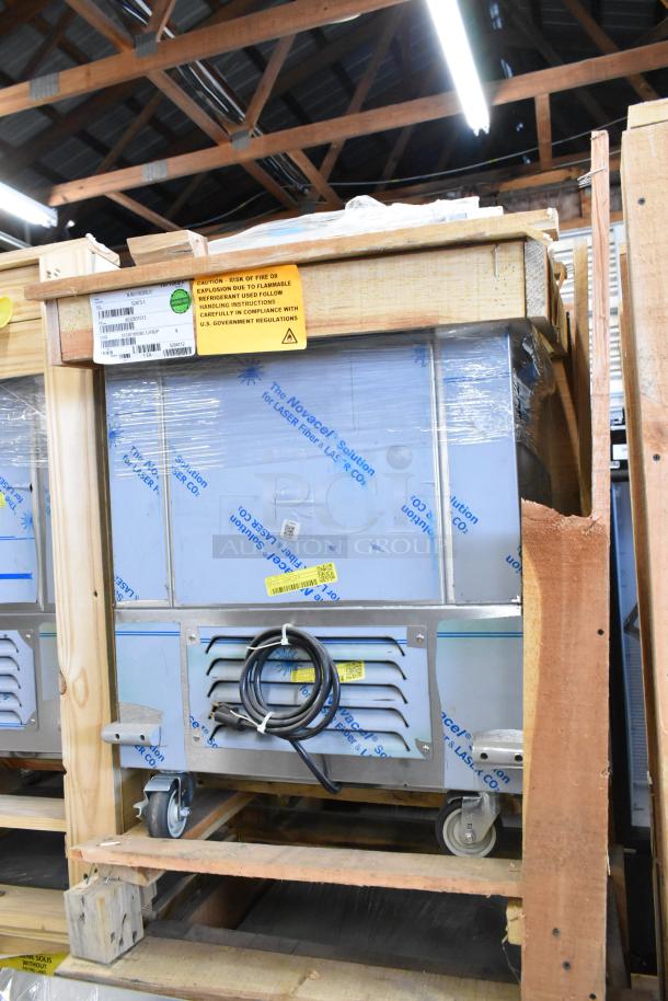 Brand new BKI 52473-1 stainless steel commercial meat freezer, on casters, 115V, 1 phase, in crate with caution label.
