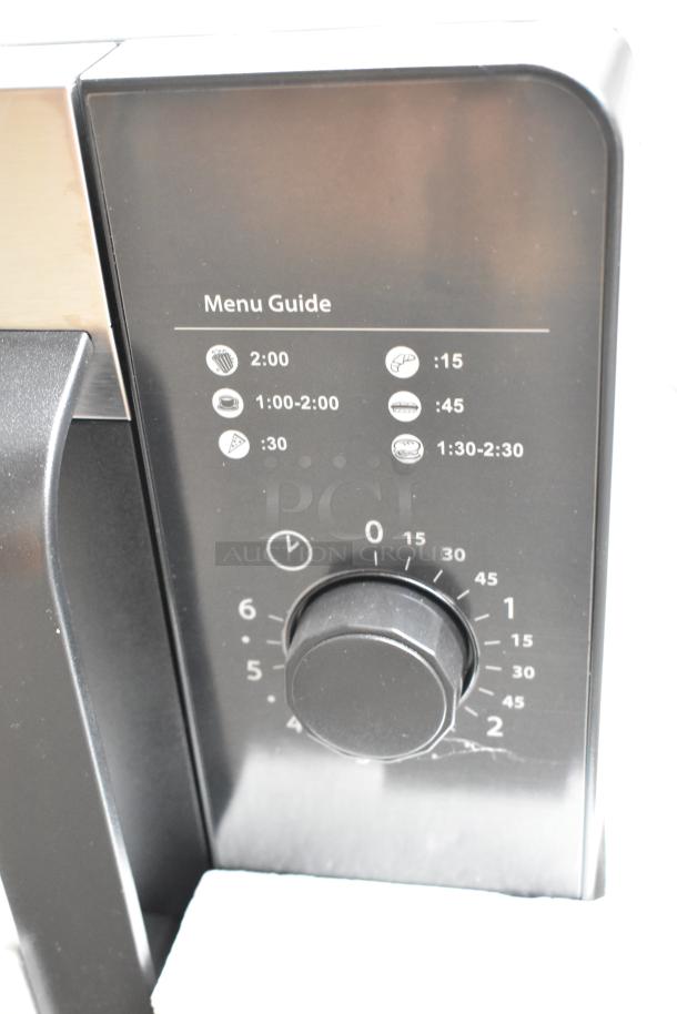 2021 Amana RMS10DSA commercial microwave, stainless steel, dial controls, new in crate, menu guide visible.