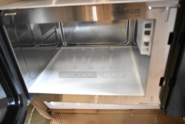 Brand new Amana RMS10DSA stainless steel commercial microwave, 2021 model, with dial controls, interior view.