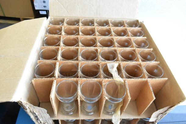 Box of 16 brand new Libbey 6 oz pilsner glasses, scratch and dent condition, in original packaging with cardboard dividers.
