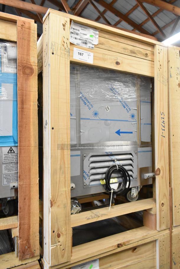 Brand new 2022 BKI 52473-1 stainless steel commercial meat freezer in crate, with casters, 115V, 1 phase, tags visible.