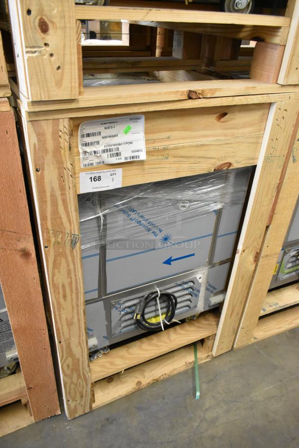 Brand new BKI 52473-1 stainless steel commercial meat freezer on casters, crated. 115V, 1 Phase. Model and shipping labels visible.