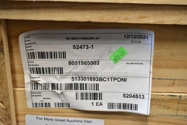 BRAND NEW BKI 52473-1 Commercial Meat Freezer, stainless steel, on casters, 115 volts, 1 phase, in crate. Label shows model details.